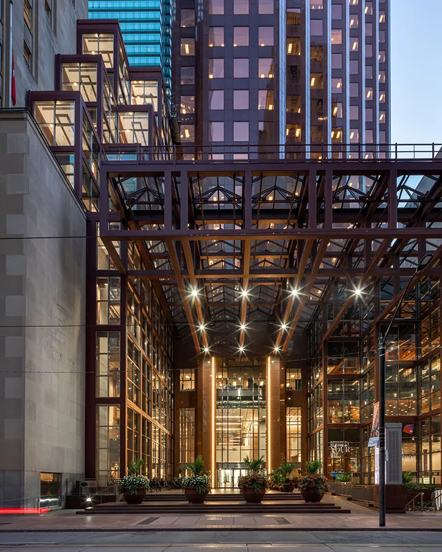 The glass atrium of Scotia Plaza in downtown Toronto at dusk.